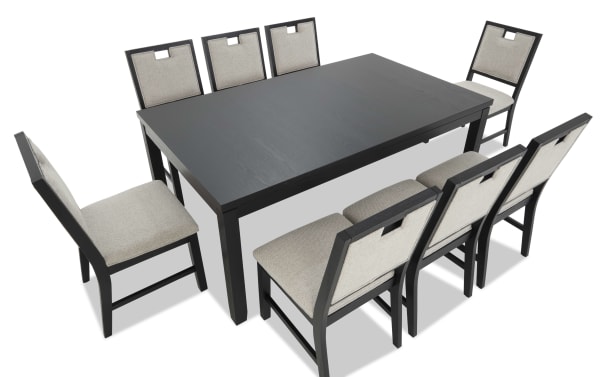 Rectangular black wood dining table with eight cushioned chairs featuring beige fabric upholstery and black wooden frames, modern style.