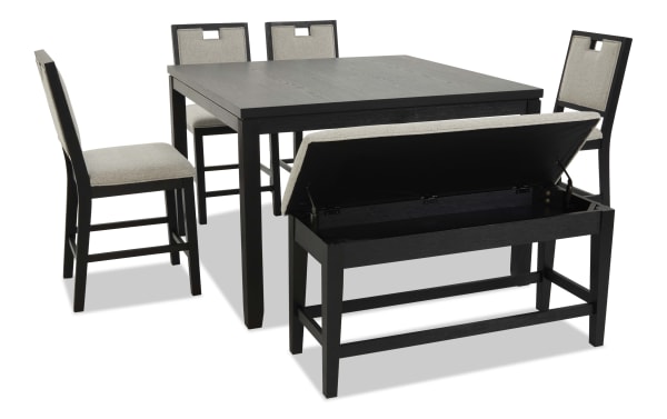 Black wooden dining table set with four beige upholstered chairs and a matching storage bench with lift-up seat, modern style.