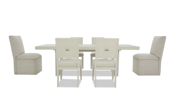 Modern beige dining set with a rectangular table and six chairs, featuring fabric upholstery and a minimalist design, ideal for contemporary dining rooms.