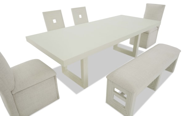 Modern dining set with a rectangular white wood table, two square-back chairs, two upholstered beige fabric chairs, and a matching bench.