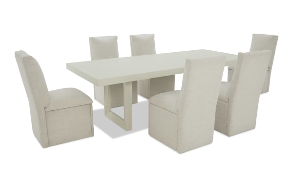 Modern dining set with a rectangular white tabletop and six beige upholstered fabric chairs featuring high backs and cushioned seats.