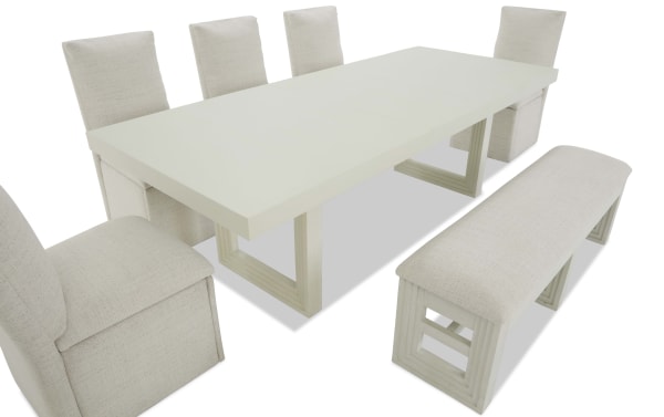 Dining set with a rectangular white wooden table, six beige upholstered chairs, and a matching cushioned bench, modern style.