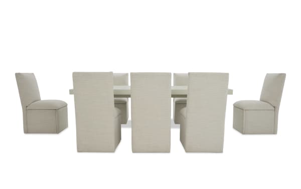 Modern dining set with a white rectangular table and eight beige upholstered fabric chairs, featuring clean lines and a minimalist design.