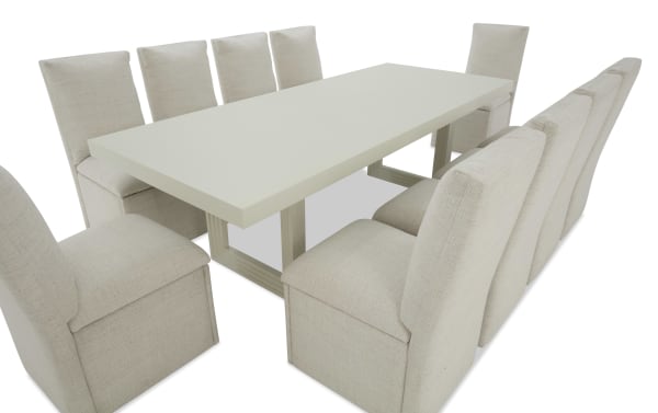 Rectangular modern dining table with a light wood base and beige upholstered high-back chairs, seating 10, suitable for contemporary dining rooms.