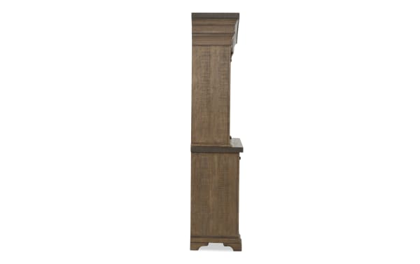 Tall wooden cabinet side view showing rich brown finish, detailed wood grain texture, and classic crown molding design.