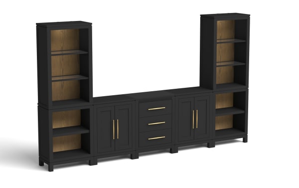 Black modular storage unit with matte finish, featuring two tall open shelves with wood-grain back panels, two cabinets with gold handles, and a central section with three drawers and gold handles. Designed for living room or office organization, combining open and closed storage with a modern, elegant style.