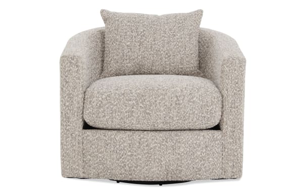 Beige and cream textured fabric swivel armchair with a rounded back and matching cushion, designed for modern living room comfort.