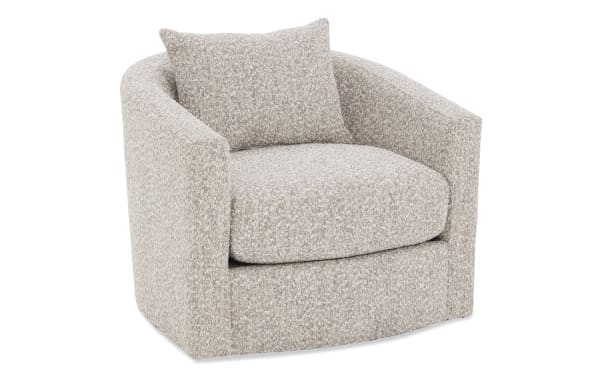 Beige and white textured fabric swivel armchair with a rounded back and matching cushion, designed for modern living room comfort.