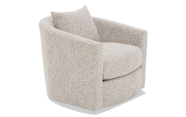 Beige textured fabric swivel armchair with rounded back, thick seat cushion, and matching lumbar pillow, ideal for living room seating.
