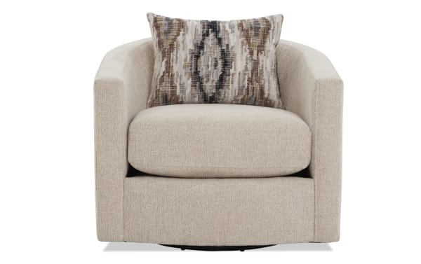 Beige textured fabric swivel armchair with rounded arms and a patterned brown, beige, and black accent pillow for modern living room seating.