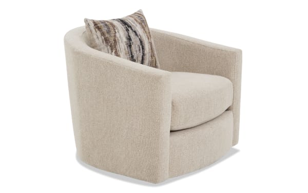 Beige upholstered swivel armchair with rounded back and arms, featuring a textured fabric and a decorative multicolor accent pillow.