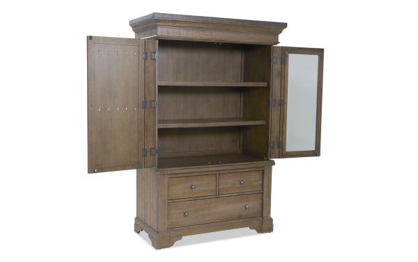 Wooden armoire with two open doors, two interior shelves, and three drawers, featuring a natural brown finish and metal knobs.