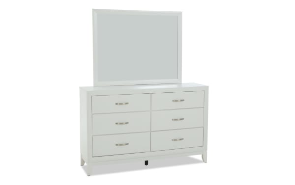 White wooden dresser with six drawers and brushed metal handles, topped with a matching rectangular mirror, ideal for bedroom storage and decor.