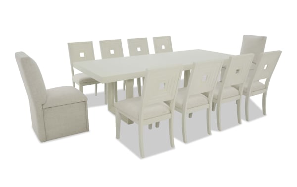Dining set with a large rectangular white wooden table and ten beige upholstered chairs, featuring cushioned seats and square cut-out backrests, suitable for modern dining rooms.