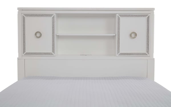 White wooden bed headboard with built-in storage shelves and two decorative cabinet doors featuring silver trim and round metal handles.