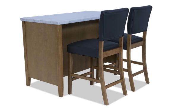 Wooden kitchen island with white marble countertop paired with two navy blue cushioned wooden bar stools, modern dining furniture set.