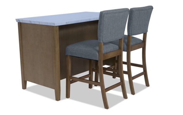 Wooden kitchen island with a white marble countertop paired with two gray upholstered bar stools featuring wooden legs and backrests.