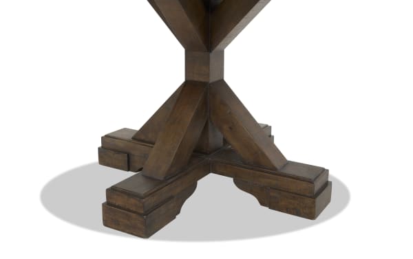 Dark brown wooden table base with a sturdy cross-shaped design and thick, angled support beams, showcasing rustic craftsmanship.