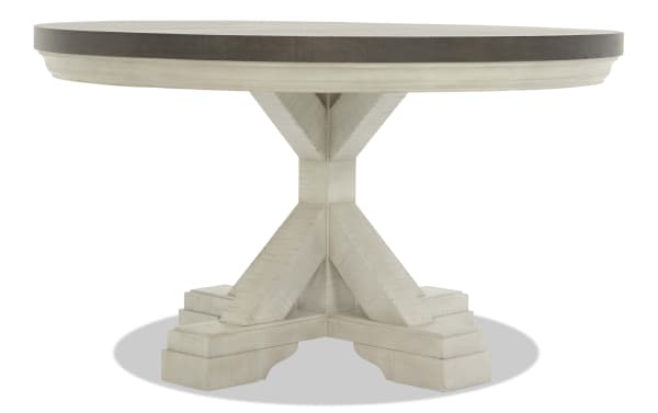 Round wooden dining table with a dark brown top and a white distressed pedestal base featuring a tri-leg design, suitable for farmhouse or rustic decor.