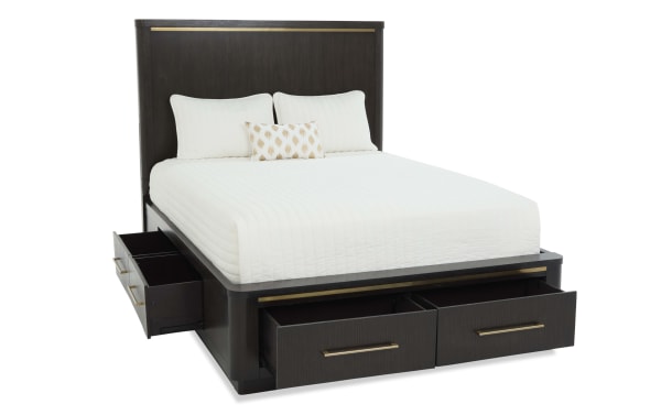 Dark wood platform bed with built-in storage drawers on sides and footboard, featuring a tall headboard and white bedding with pillows.