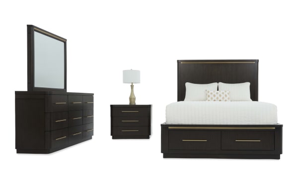Dark wood bedroom set with a dresser and mirror, three-drawer nightstand with brass lamp, and a bed featuring storage drawers and brass accents.