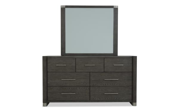 Dark wood dresser with six drawers and three smaller top drawers, featuring sleek metal handles and a matching framed mirror, modern bedroom furniture.
