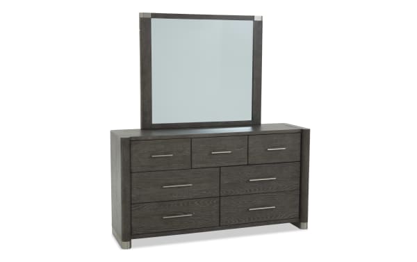 Dark gray wood dresser with six drawers and three smaller top drawers, featuring silver handles and a matching rectangular mirror with silver corner accents.
