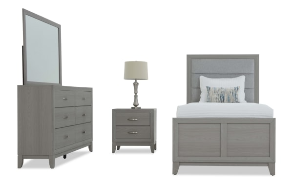 Gray wood bedroom set with upholstered headboard bed, matching dresser with mirror, and nightstand with table lamp, modern style