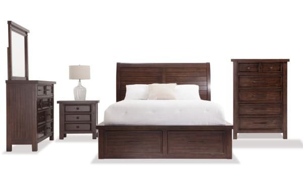 Hudson 5 Piece Queen Pecan Storage Platform Bedroom Set in transitional style with paneled sleigh bed, six storage drawers, dresser, chest, and nightstand. Made of rubberwood, pine solids, MDF, mango veneers, plywood with pewter hardware. Includes power outlets and USB charging ports. Rich pecan finish enhances wood grain character.