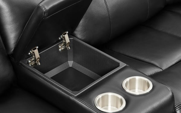 Black leather reclining sofa center console with storage compartment and two stainless steel cup holders, showcasing modern home theater seating features.