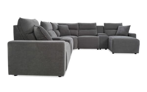 Large modern sectional sofa in dark gray fabric with plush cushions, chaise lounge, and wide armrests, ideal for spacious living rooms.