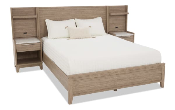 King-size wooden bed frame with integrated nightstands, light oak finish, white bedding, and modern minimalist design.