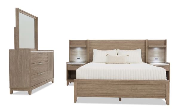Modern bedroom set featuring a king-size wooden bed with built-in nightstands and LED lights, paired with a matching dresser and mirror in light oak finish.