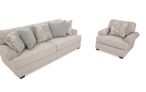Beige fabric living room set with a three-seater sofa and matching armchair, featuring patterned and solid decorative cushions, modern style.