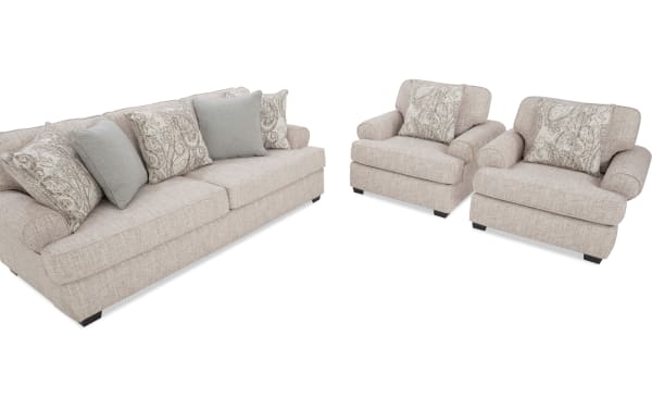 Beige fabric living room set including a three-seater sofa and two armchairs with rolled arms and patterned throw pillows, featuring a textured woven upholstery.