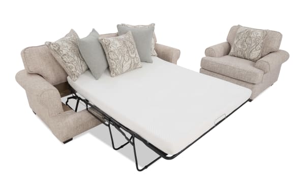 Beige fabric sectional sofa with a pull-out metal frame queen sleeper mattress, featuring patterned and solid decorative pillows for added comfort and style.