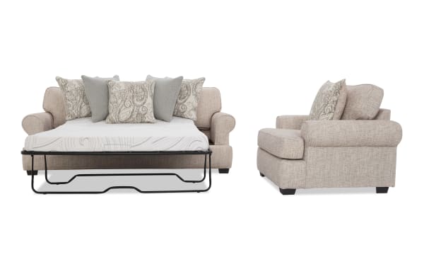 Beige fabric sleeper sofa with rolled arms, patterned and solid throw pillows, shown in open bed and side chair view.