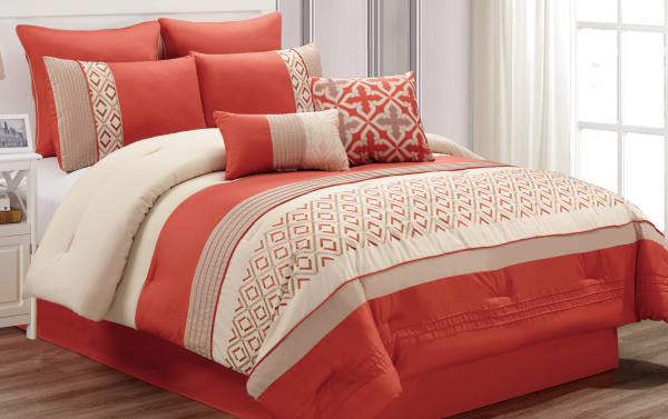 Marcella Queen 7 Piece Comforter Set in orange, white, and gold polyester fabric with geometric patterns, decorative pillows, and transitional style.