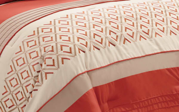 Marcella Queen 7 Piece Comforter Set in orange, white, and gold polyester fabric with geometric pattern and horizontal stripes, transitional style.