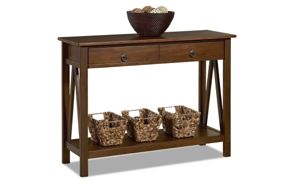 Apollo 42'' Brown Storage Console Table from Apollo Entertainment & Occasional collection, transitional style, pine solids and MDF, features two drawers, open bottom shelf with three woven baskets, and a decorative bowl on top.