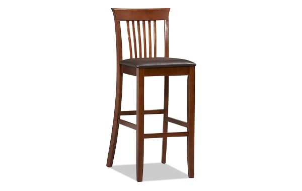Craftsman Dark Cherry Slat Back Bar Height Stool with dark brown vinyl padded seat, rubberwood frame, and transitional Mission-style design.