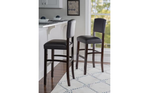 Venice Espresso bar height stool with padded espresso polyurethane seat and back, rubberwood legs, tapered design, and foot rails for stability.
