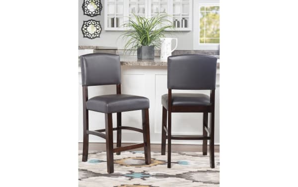 Venice Espresso faux leather upholstered counter height stool with padded vinyl seat and back, tapered rubberwood legs, and foot rails for stability.