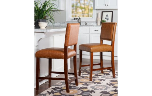 Marie Camel faux leather upholstered counter height stool with nailhead trim, rubberwood frame, and contemporary camel brown finish for kitchen seating.