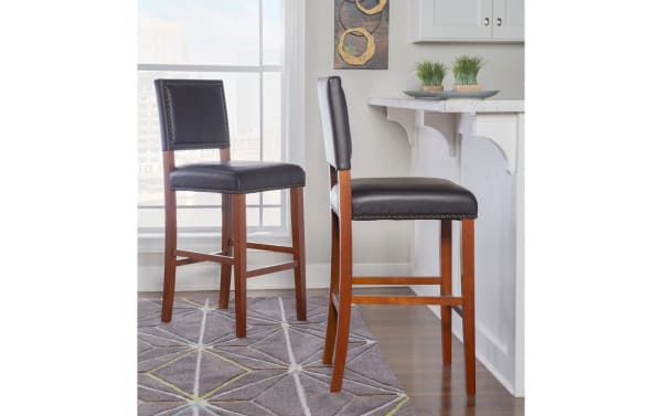 Marie Cherry & Black faux leather upholstered bar height stool with nailhead trim, rubberwood frame, and contemporary style for kitchen counters.