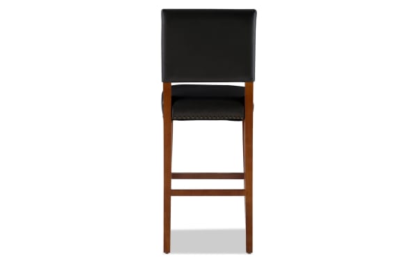 Contemporary Marie Cherry & Black bar height stool with black faux leather upholstery, nailhead trim, and solid rubberwood frame for casual dining.