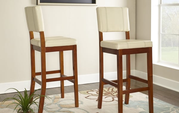 Naples Cream Faux Leather Upholstered Bar Height Stool with cream polyurethane seat, solid rubberwood legs, and transitional style for durable, stain-resistant seating.