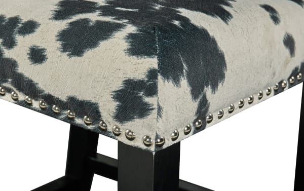 Corey Black & White Upholstered Counter Height Stool with cowprint polyester fabric, matte black rubberwood legs, and silver nailhead trim in traditional style