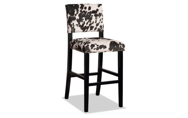 Corey Black & White Upholstered Bar Height Stool with cowprint polyester fabric, matte black rubberwood frame, silver nailhead trim, traditional style