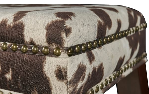 Kristen Cow Print Walnut Backless Upholstered Bar Height Stool with brown polyester fabric, traditional style, rubberwood frame, and decorative brass nailhead trim.